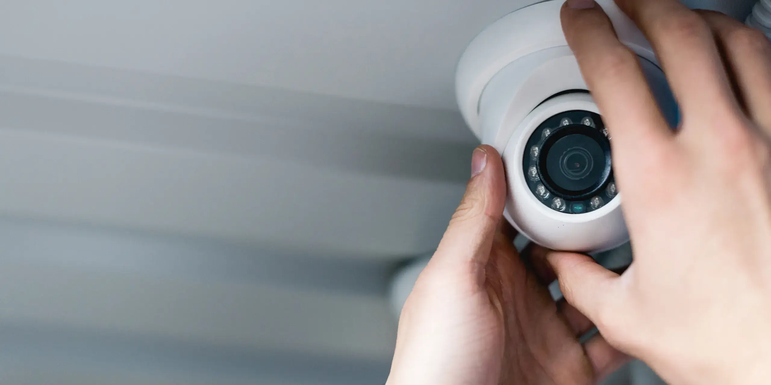 cropped-view-of-man-setting-up-security-camera-2024-11-18-04-15-53-utc